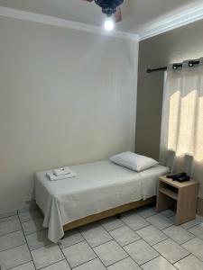 Postel nebo postele na pokoji v ubytování Hotel Parati Arapongas