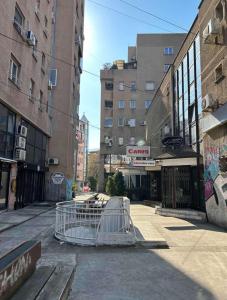 a shopping cart on a city street with buildings at Central Location with parking by He-Ra Apartments Skopje in Skopje