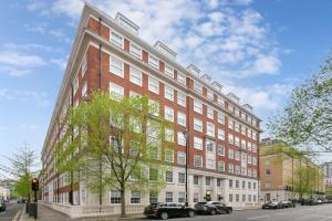a large red and white building on a city street at Luxe 2 Bed Apartment in heart of Soho in London