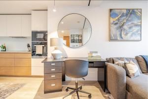 a living room with a desk and a couch at Luxe 2 Bed Apartment in heart of Soho in London