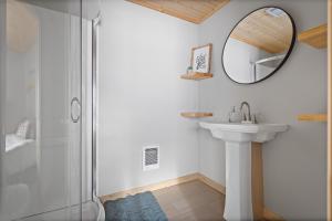 a bathroom with a shower and a sink and a mirror at Anchor Bay in Pequot Lakes