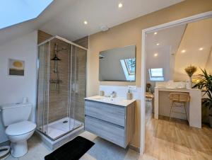 a bathroom with a shower and a toilet and a sink at Ibiza- l'escapade a saint Brieuc in Saint-Brieuc