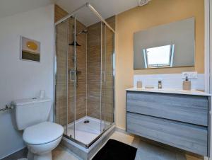 a bathroom with a toilet and a glass shower at Ibiza- l'escapade a saint Brieuc in Saint-Brieuc +5 photos
