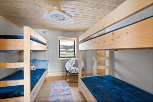 a bedroom with two bunk beds and a chair at Anchor Bay in Pequot Lakes +18 photos