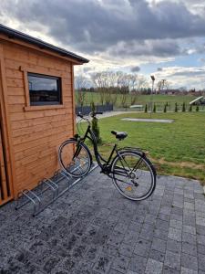 a bike is parked next to a building at Apartamenty Szepty Mazur in Odoje
