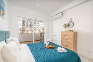 a bedroom with a bed with a tray of food on it at HostWise – Seaside Escape with Balcony in Silves