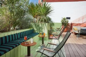 a row of chairs and tables on a patio at The Social Hub Madrid Extended Stay in Madrid
