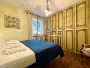 リミニにあるGrande villa al mare - Casa Goldoniの青い毛布が掛けられたベッドのある寝室