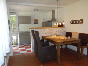 a dining room with a wooden table and chairs at Domizil am Park in Kressbronn am Bodensee