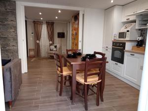 a kitchen with a wooden table and chairs in a room at G&S Apartment in Trapani