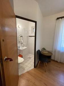 a bathroom with a shower and a toilet and a table at Willa Anna in Szczawno-Zdrój