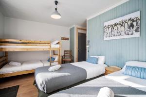 a bedroom with two beds and a bunk bed at CHALET AUBERGE - Les Mélèzes in Tignes