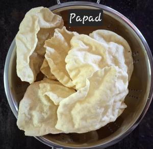 a bowl filled with tortilla crisps sitting on a table at Karur Homes in Kodaikānāl