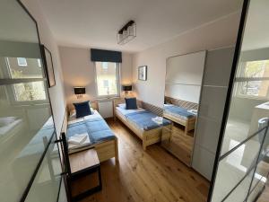 a small room with two beds and a mirror at Nowy Apartament Mikołowska Premium in Gliwice