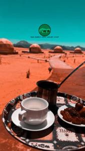 a tray with a cup and plates of food on a table at RUM BUBBLES VIEW lUXURY CAMP in Wadi Rum +56 photos