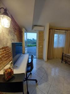 a room with a desk with a laptop on it at La Collina in Sacrofano
