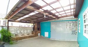 a building with a large door with a roof at Pousada e Hospedaria Alternativa Ladi Laura in Urubici