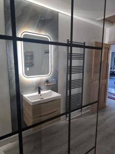 a bathroom with a sink and a mirror at Petite retreat in Templepatrick +15 photos