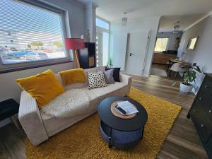 a living room with a couch and a table at Dagmars Apartment in Steinwenden