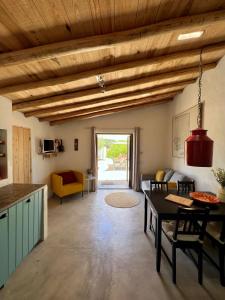 a kitchen and living room with wooden ceilings at Quinta da Vida in Moncarapacho