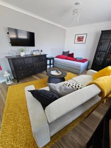 a living room with a couch and a tv at Dagmars Apartment in Steinwenden