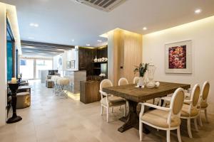 a kitchen and dining room with a wooden table and chairs at Kate and Hasu Boutique Chiangmai in Chiang Mai