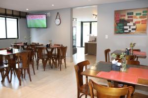 a restaurant with tables and chairs and a tv on the wall at HOTEL CORTESE in Teresina