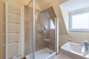 a bathroom with a shower and a tub and a sink at Dat lütte Huus - Wohnung 1 in Husum