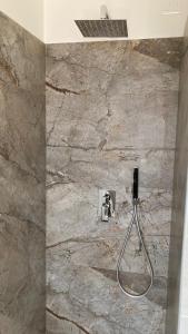 a shower in a bathroom with a marble wall at Seia Mountain Wellness in Mezzolago +64 photos