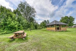 a picnic table and a gazebo in a field at Mountainside Resort F302 in Stowe
