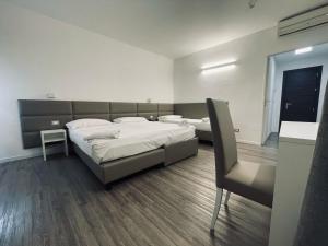 a bedroom with a large bed and a desk at Hotel Holiday- Alla Finestrella in Bologna
