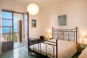 a bedroom with a bed and a balcony at Villa Maria Lake View,7 minuti a piedi dal centro, parcheggio privato in Torri del Benaco +60 photos