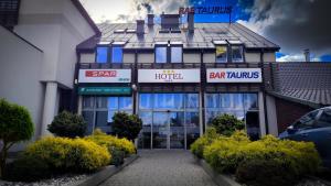 a hotel with a car parked in front of it at Taurus Ładna in Tarnów