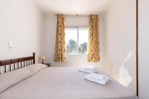 a bedroom with a bed with two towels on it at Rentalmar Los Angeles in Miami Platja +48 photos