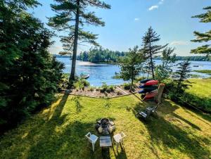 an aerial view of a lake with a tent and chairs at Lake Life Waterfront Cabin NEW in Franklin Road