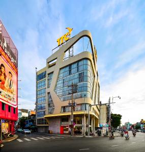 a tall building with a mtn sign on top of it at TTC Hotel Deluxe Airport in Ho Chi Minh City