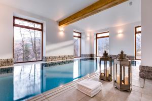 an indoor swimming pool with windows and a swimming poolvisorvisor at Zamek Księża Góra in Karpacz