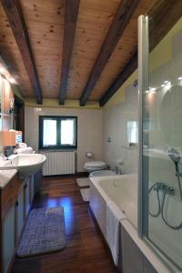 a bathroom with two sinks and a tub and a shower at Lake Breeze Salò in Salò