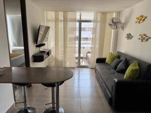 a living room with a couch and a table at Polanco Residences Tocagua Cartagena - Colombia in Cartagena de Indias
