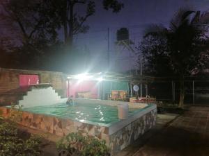 a person in a swimming pool at night at Casa pura vida Rivas in Rivas