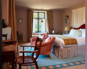 a hotel room with a bed and a chair at Penmaenuchaf Hotel in Dolgellau
