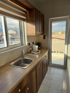 a kitchen with a sink and a window at DIVINUS Luxury Stay in Markopoulo +52 photos