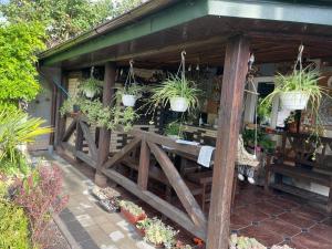 a wooden fence with potted plants on it at Готель GUEST HOUSE Сауна in Radekhov