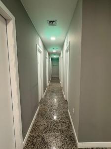 a hallway with a long corridor with white doors at Comfort Zone in Porto Alegre +4 photos