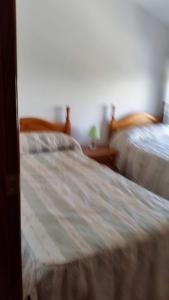 En eller flere senge i et værelse på Casa Avenida Guadalquivir