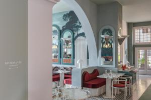 a dining room with tables and red chairs at Il Palazzo Experimental in Venice