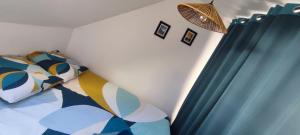 a bedroom with a bed and a blue curtain at Studio centre ville Rodez in Rodez