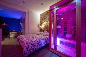 a room with a bed with purple lights in it at Suite pour les Amoureux_Val d'Europe Disney in Coupvray