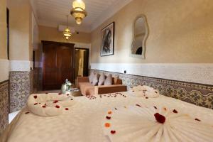 a hotel room with a bed with flowers on it at Riad Atlas Dama in Marrakech