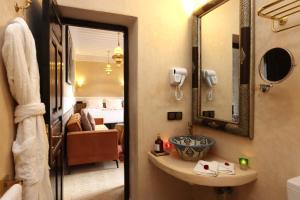 a bathroom with a sink and a mirror at Riad Atlas Dama in Marrakech